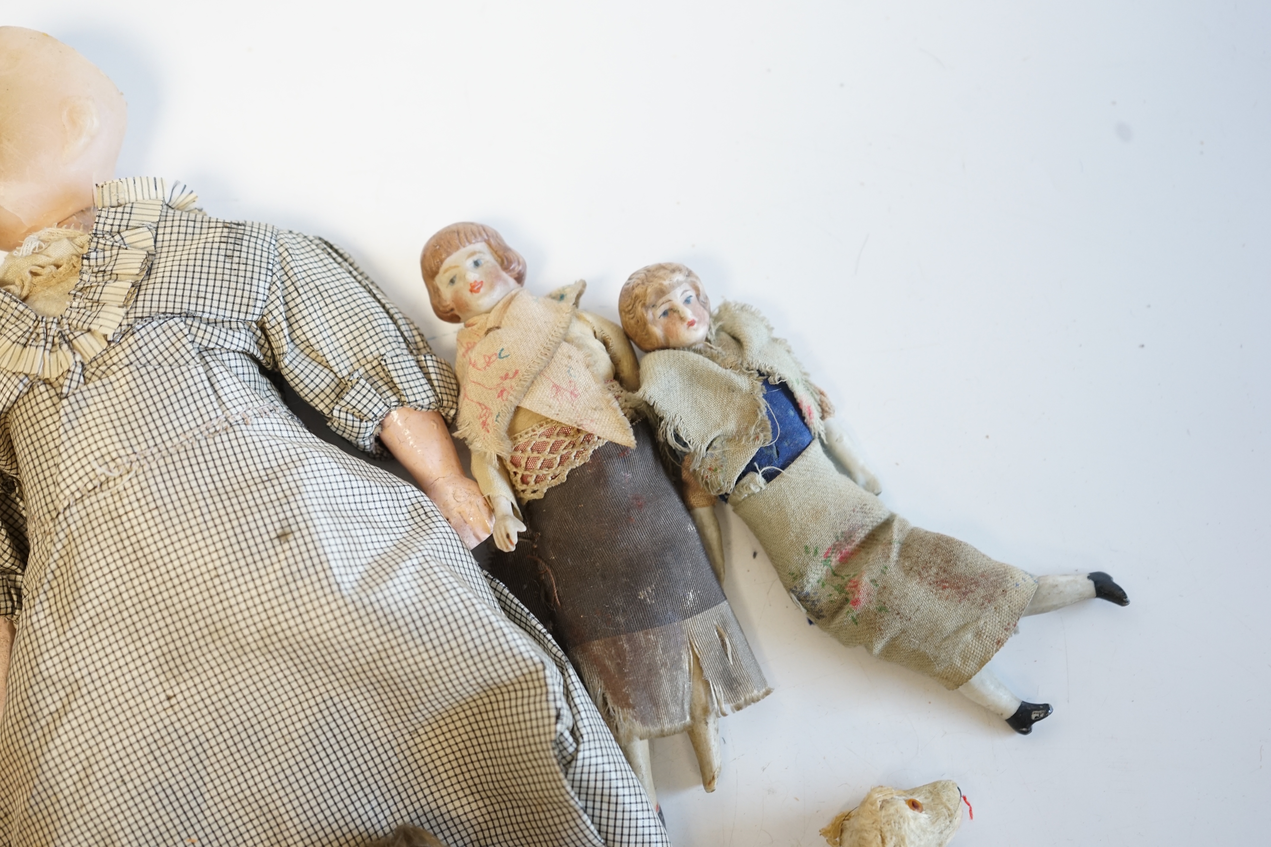 Eleven doll's house dolls, 19th and early 20th century, including two Kammer & Reinhardt bisque jointed dolls and a wax over composition doll in original clothes (12). Condition - fair